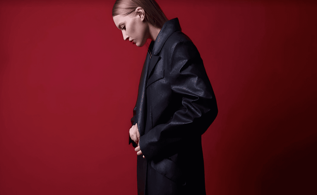 A cinematic fashion composition against a deep red background